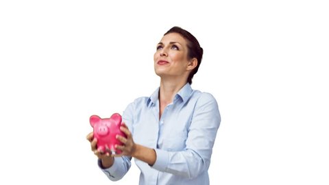 Woman in slow motion throwing her piggy bank against a white background in slow motion