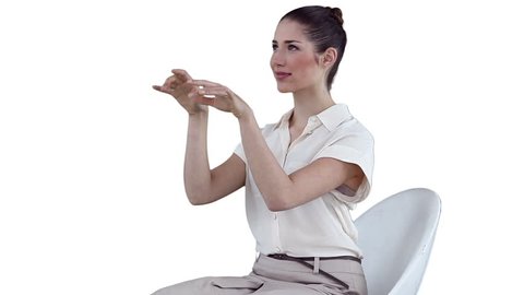 Brunette businesswoman using on a virtual keyboard against a white background