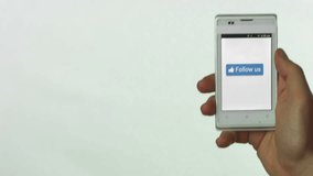 White smartphone held in hand, Follow Us button pressed on the touch screen - Powered by Shutterstock - Get 15% off with code: PIKWIZARD15