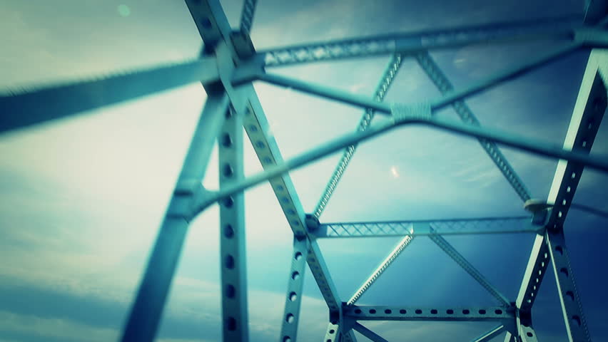 Driving over a steel bridge.  Looking up perspective.
