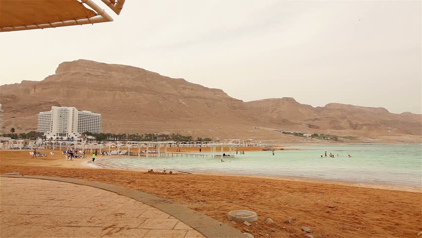 Rest and treatment at the Dead Sea in Israel, resort, hotel, exterior, treatment, people bathing in the Dead Sea, sandy beach, azure coast of the Dead Sea, medicine, white-crystal salt