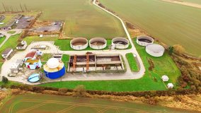 Camera flight over biogas plant from pig farm. Renewable energy from biomass. Modern agriculture in Czech Republic and European Union. 