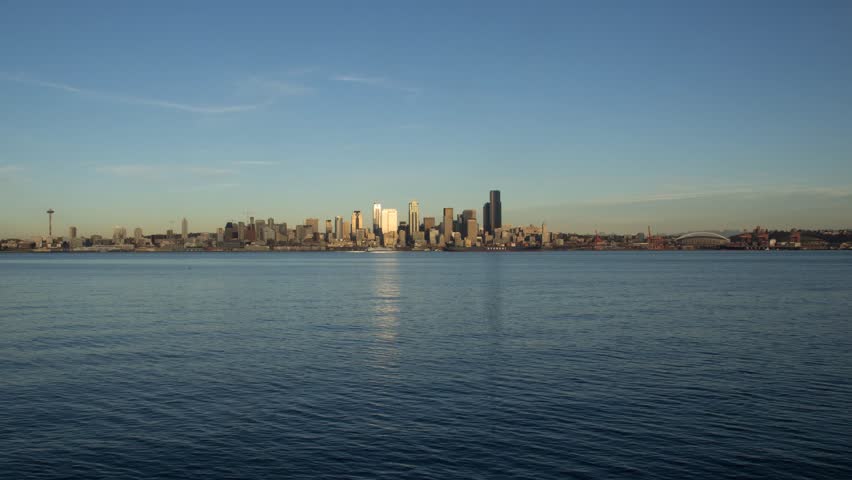 Time lapse scene showing a complete day to night transition of the Seattle skyline  as seen from Alki Beach