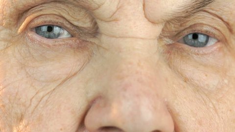 Old woman's face with disturbing look of face. Close up