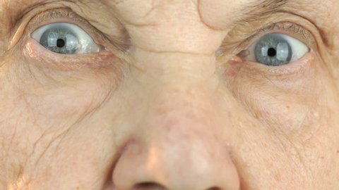 Old woman's face with tired expression of face. Close up