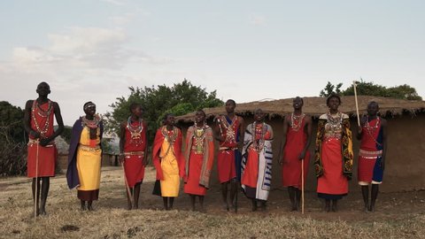 maasai women and men sing then dance together in pairs at a village near masai mara in kenya
