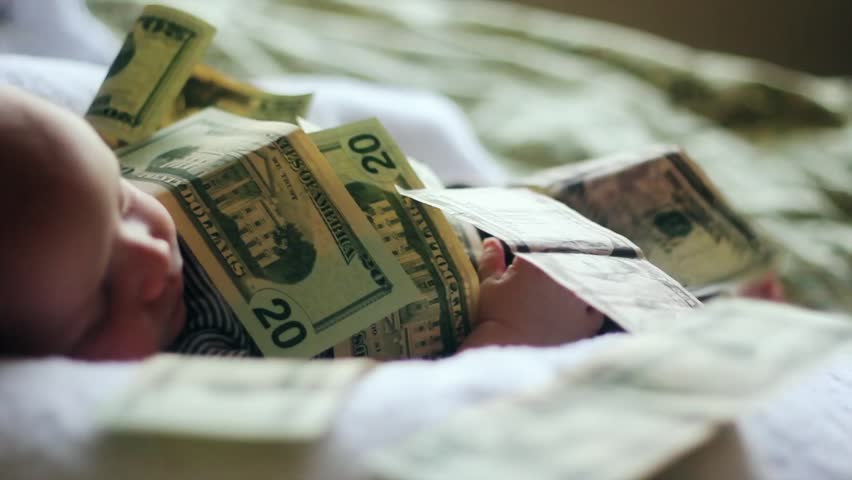 A baby lying in a pile of cash. (Babies are expensive)