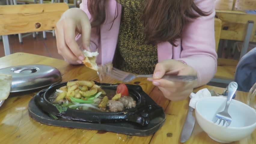 girl eating beef steak