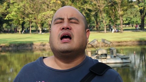 Asian Thai bald head fat man is showing funny horny moaning spasm facial expression and it goes overwhelming with lust in sex concept HD.
