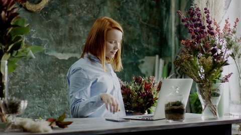 florist typing on laptop