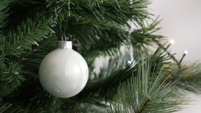 Reflective Christmas tree white bauble close-up 4K 2160p 30fps UltraHD footage - Shiny glass New Year night decorative ornament 3840X2160 UHD video