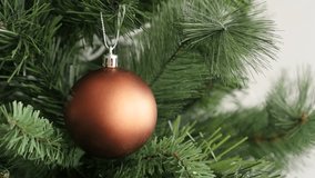 Elegant bronze color round ornament for New Year night backgrounds 4K 2160p 30fps UltraHD footage - Luxurious matte Christmas tree bauble shallow DOF decoration  3840X2160 UHD video