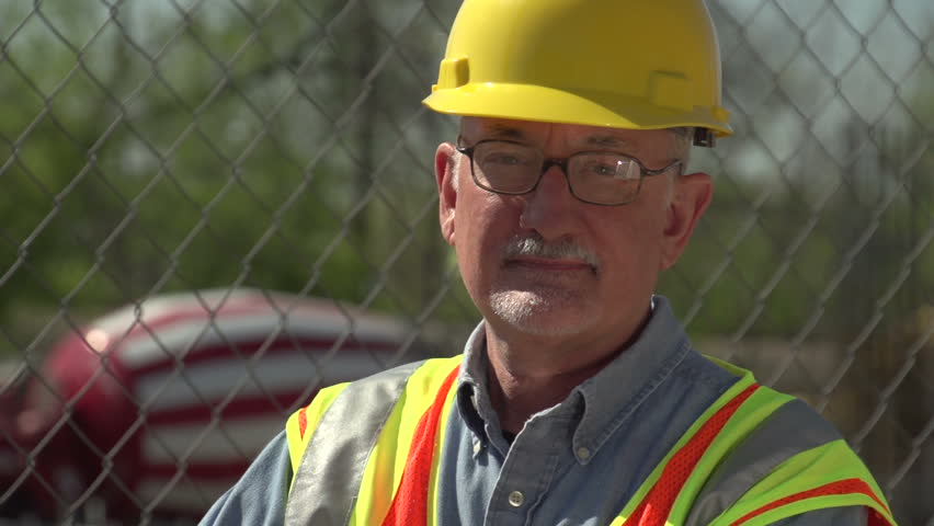 Construction worker on site, looking at camera, close up