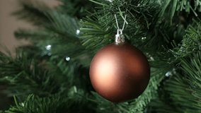 Shallow DOF round bronze color ornament for New Year night slow motion 1920X1080 HD footage - Luxurious matte Christmas tree bauble decoration slow-mo 1080p FullHD video