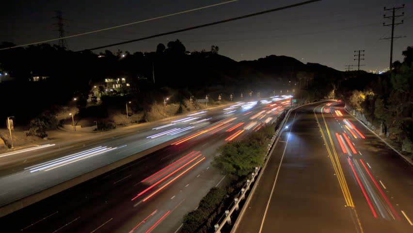 Highway Traffic at night with carlights passing by