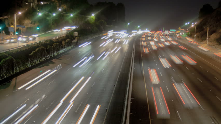 Highway Traffic at night with carlights passing by
