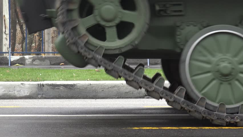 4K Close up of military track machinery with heavy wheels in war, artillery technology by day