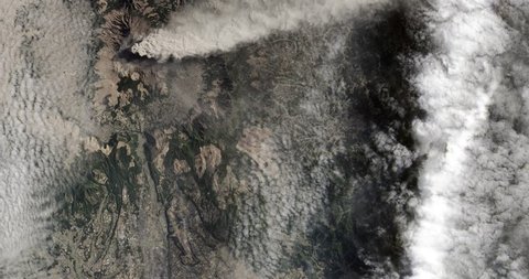 High-altitude overflight aerial of volcanic activity on Mount Aso, Japan's Kyushu island. Clip loops and is reversible. Elements of this image furnished by NASA