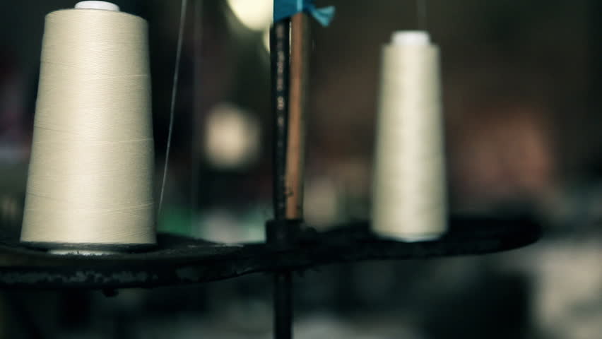 Close up of white string which is used on a vintage sewing machine.