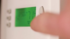 Digital thermostat used for heating and cooling - Energy expense and finance concept