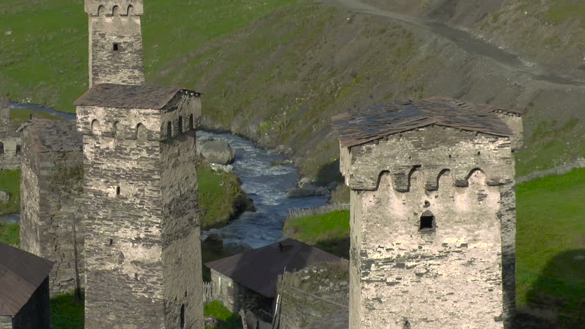 Svaneti Old village in Georgia. Medieval tower built for defensive purposes. Each family had its own tower. In the background a mountain river