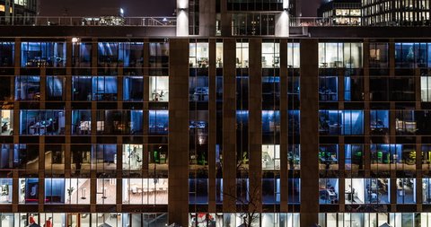 TIME LAPSE: Glass Office Building, Light in the Windows Turning on and off, dusk. 4K. Modern business and conference centre. Career and Employment concept. Corporate life. City rush hour.