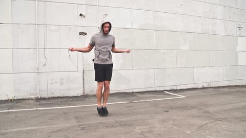 Athletic male working out in an empty parking lot. Crossfit. Slow Motion.