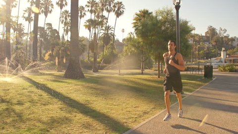 Man jogging through a park in Los Angeles. Slow Motion.