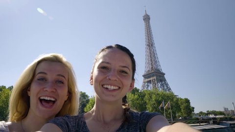 Happy Young Women Pose For Fun Selfies On A Tour Boat Floating Down The River Seine In Paris, Eiffel Tower Prominent In Background