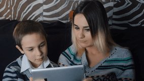 Happy family - mother and kid using tablet pc. Slow motion