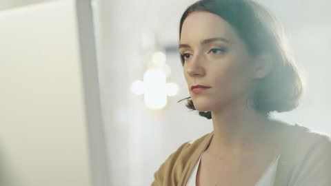 Beautiful Creative Woman Sits at Her Office Working On a Computer. Shot on RED Cinema Camera in 4K (UHD).