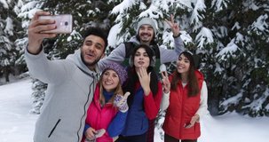 Group Of People Winter Snow Forest Smiling Friends Using Smart Phone Internet In Snowy Park Slow Motion 60