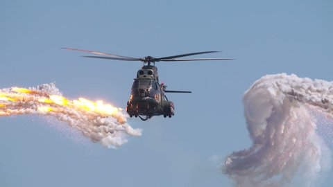 Helicopter launched anti missile flares in a slow motion scene. Stealth evasive maneuvers