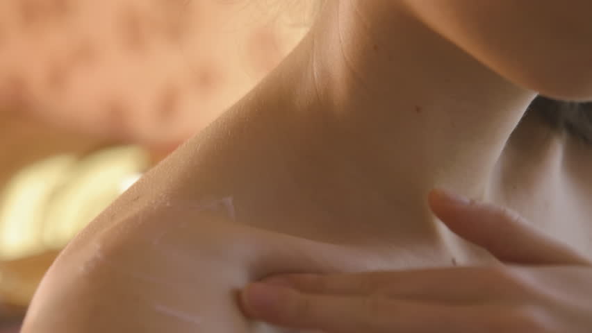 Young beautiful woman applying cream on her neck at the morning | Shutterstock HD Video #22206403