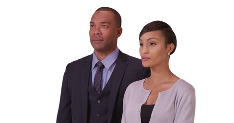 Black business couple posing for a portrait on a white background. African American people standing on a blank backdrop. 4k