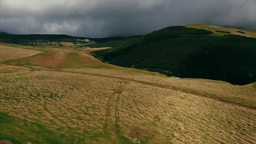 Aerial shot of a highland serpentine mountain road