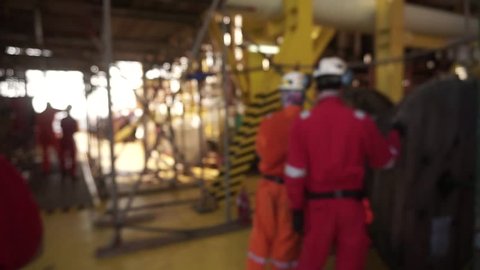 Motion blur Effect. A group of offshore workers performi cable pulling activities for new installation oil and gas platform using manual method.