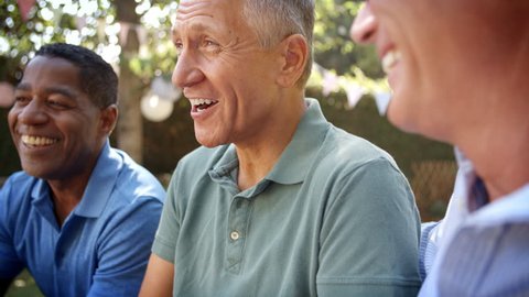 Mature Male Friends Socializing In Backyard Together  : vidéo de stock