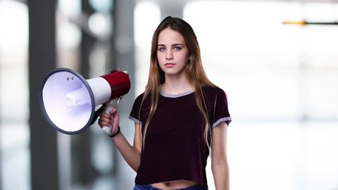 young woman shouting on the megaphone