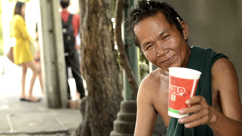 BANGKOK - CIRCA MAY 2012: Beggar smiling and asking for change circa May 2012 in