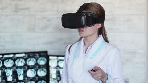 Doctor watching computed tomography shot using vr headset