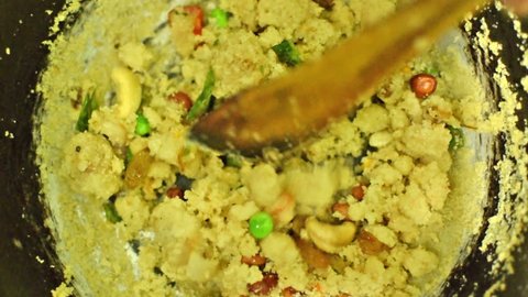 Preparation of Upma, a traditional south Indian breakfast food dish.It is made of Rava, which is called Suji in popular Hindi Language in India and cream of wheat in English.Upma is Indian delicacy.