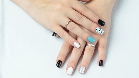 Female hand with trendy manicure. Nail design on a white background closeup