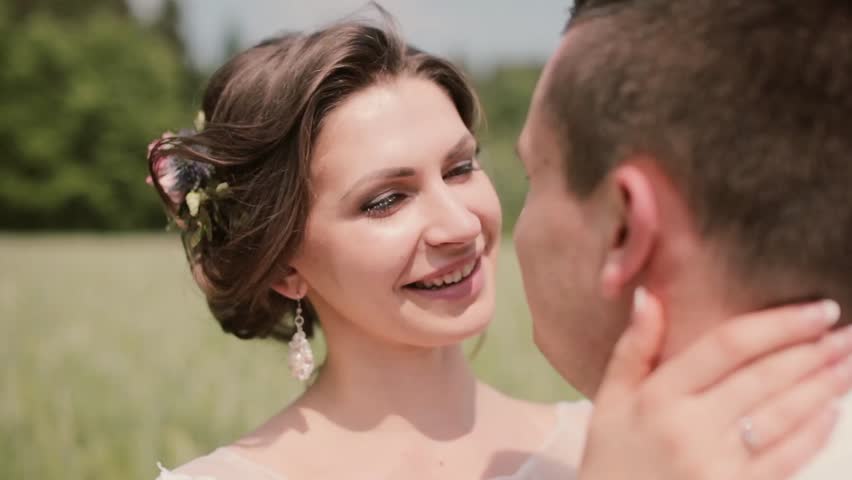 Close-up of young beautiful woman with a pretty hair-do kissing her man, smiling and tenderly looking at him | Shutterstock HD Video #22249081