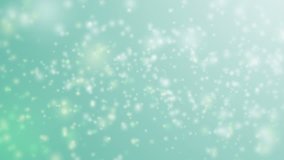 Soft beautiful blue and green backgrounds.Moving gloss particles on blue and green background loop. Winter theme Christmas background with snowflakes.