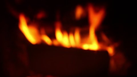 Burning fire with wood and logs in fireplace. Blurred Fire background