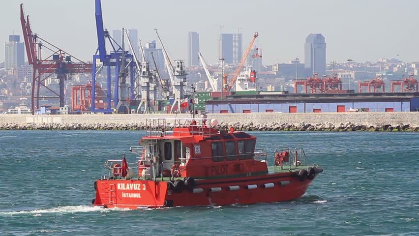 ISTANBUL - APRIL 28: Tug boat KILAVUZ 3 maneuvering in front of docks on April