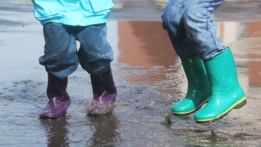 Kids in Rain Boots Jumping Stock 