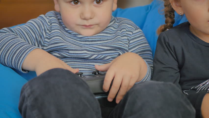 Cute girl and boy playing a game on the console