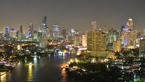 Time lapse of Chaophraya river and Bangkok aerial view at night.